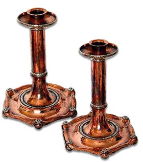 A E Jones handbeaten copper and silver candlesticks