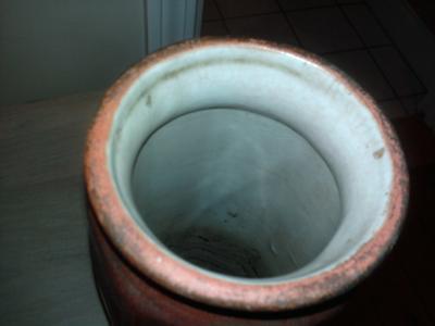 Top of rust colored vase